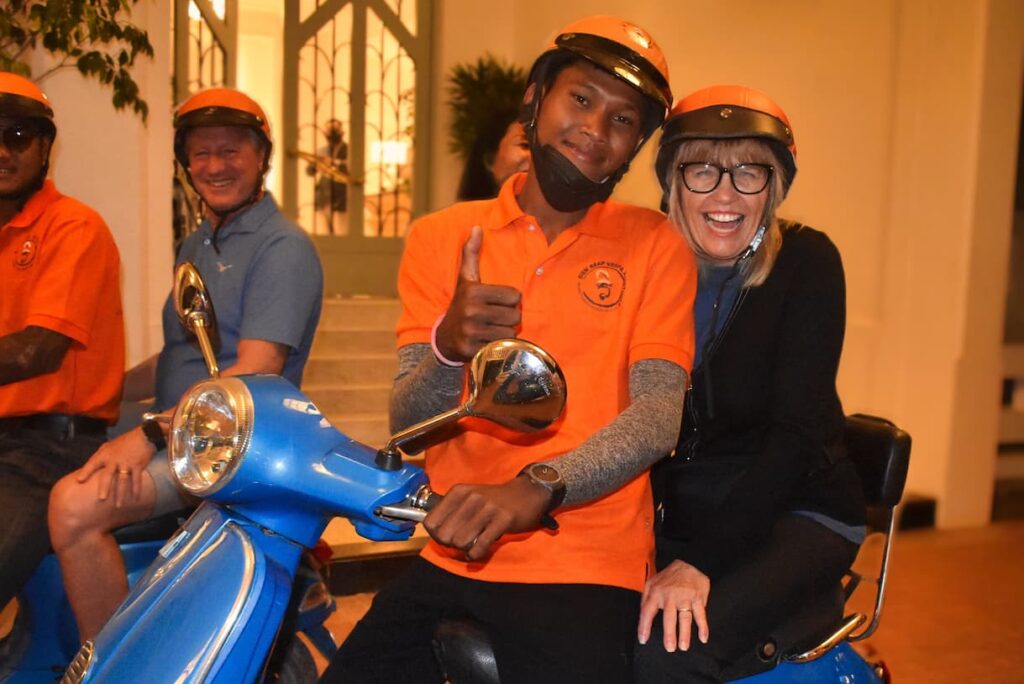 Guests and their driver on a Vespa at hotel pickup for the After Dark food tour in Siem Reap