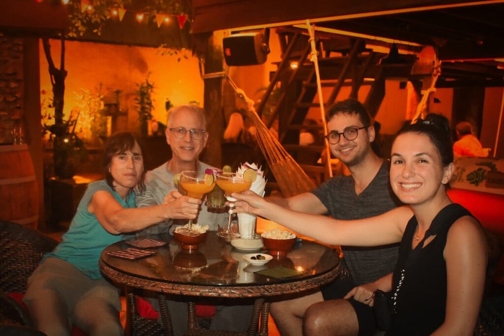 Four guests raising cocktail glasses at the final bar stop
