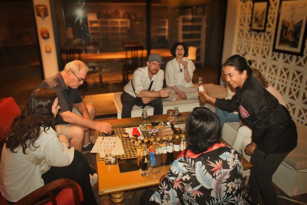 Guests around a low table tasting a flight of infused rice wines